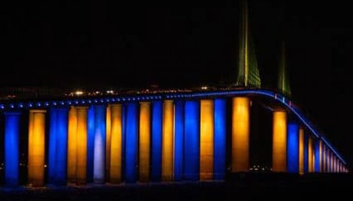 Sunshine Skyway Bridge lit in blue and gold at night